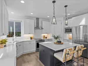 Beautifully appointed kitchen complete with quartz countertops, stainless appliance package, subway tile backsplash and step-in pantry