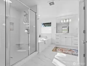 A true spa-inspired bath featuring heated tile floors, a dual head shower with tile surround, double vanities and a large soaking tub!