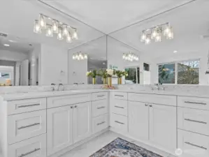 Sleek quartz counters, a classy tile backsplash and plenty of storage space