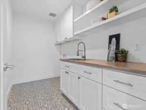 Spacious utility room offers plenty of built-in storage, in addition to the linen closet (not pictured)