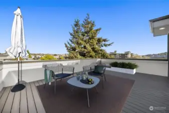 Bask in the sun on your private rooftop deck! This photo is virtually staged.