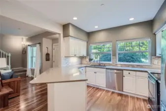 The overhang is perfect to put stools under! You will love the full height backsplash & under counter lighting