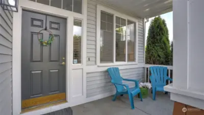 Darling covered front porch greets your guests and is perfect place to enjoy your morning coffee.