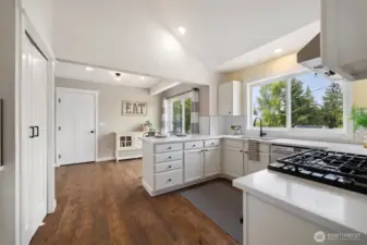 You'll love how bright the kitchen is, with white quartz counters, fresh white cabinetry and lots of light. The door straight ahead leads into the garage.