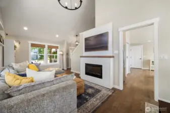 The vaulted ceilings bring in an abundance of natural lighting, and the fireplace creates a perfect setting for cozy nights.