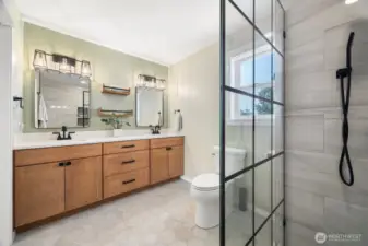 Escape to your personal retreat at the end of the day, with the spa-inspired primary bathroom featuring a walk in tile shower, warm wood cabinetry and modern finishes.