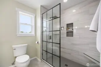 The walk in tile shower is spa-inspired, spacious, and filled with light.