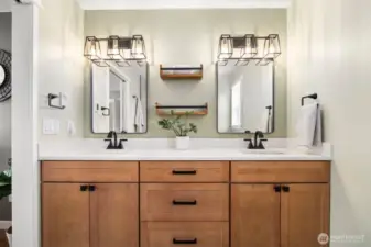 No updates needed here! This stunning primary ensuite features stylish wood vanities, quartz counters and tile flooring.