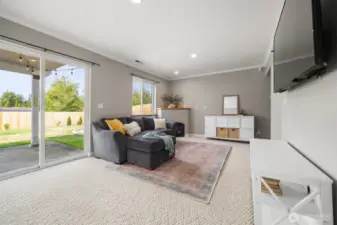 The bonus room includes sliding glass doors out into the backyard and a fireplace for cozy movie nights.