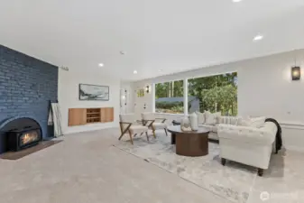 Downstairs Bonus room is ready to fun! Featuring a cozy wood-burning fireplace, handy door to the backyard and so much storage!
