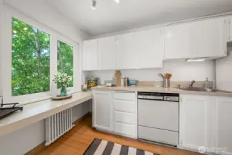 Kitchen has a lower counter for a desk, baking center or...? Still light and bright with the street trees to give you privacy but enough east facing light to wake you up with your coffee.