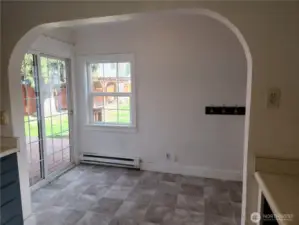 Eat-in area space with slider leading to the back deck.  To the right of the photo is a door leading to the garage.