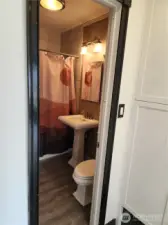 From the living room is a hallway leading to the bathroom.