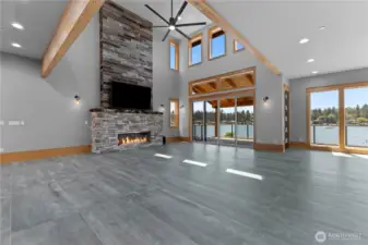 Vaulted living room with stone gas fireplace & wood wall. Wood beams, sconces. Big Fan & slider to covered back deck overlooking lake. Dining area with windows overlooking lake as well.
