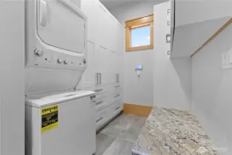 Main floor laundry/mud room with tons of cabinets