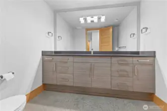 Half bath/ dressing room on lower level with huge mirror and tons of drawers