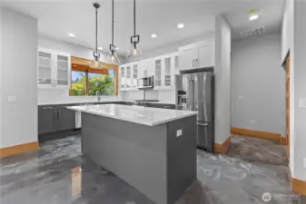 Lower kitchen with breakfast bar and all appliances, epoxy flooring