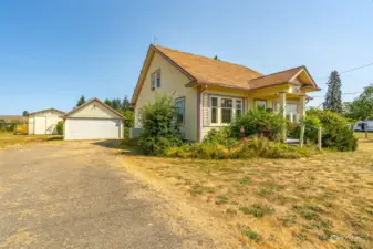 Garage behind the house and behind that a barn/shop or could be converted into a charming ADU. Great space and high ceilings.