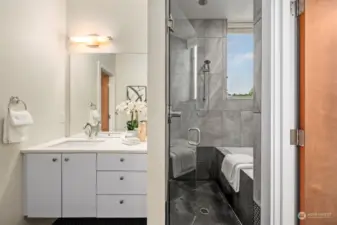 Shower and tub in tiled spa-like bathroom on the upper floor.