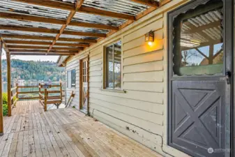 Another view; covered deck area and doors to both kitchen & living room.