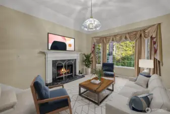 Formal living room with tray ceiling and custom wrapped natural gas fireplace. Virtually staged.