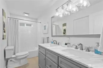 Guest bath with dual vanity has access directly from bedroom