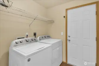 Laundry room has additional storage space.