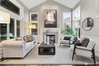 Soaring ceilings and an open ambiance create a sense of grandeur, while expansive windows frame lush outdoor views. Whether hosting intimate gatherings or savoring a quiet moment with a book, this space offers the perfect blend of elegance and comfort.