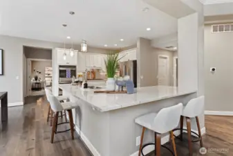 Light-filled and thoughtfully designed, the kitchen features quartz counters, stainless appliances, and ample prep space. Perfect for weekday meals or weekend hosting.