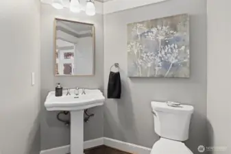 The main-floor powder bathroom combines sleek modern fixtures with thoughtful design, offering convenience and style just steps from the living areas.