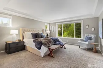 The master bedroom boasts generous space and serene backyard views, creating a peaceful retreat with plenty of room to relax and unwind.
