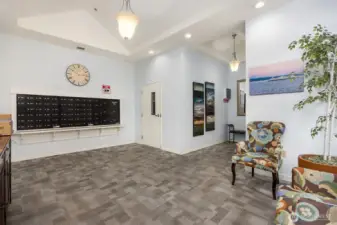 The lobby has a secure entrance, with mailboxes and seating area.