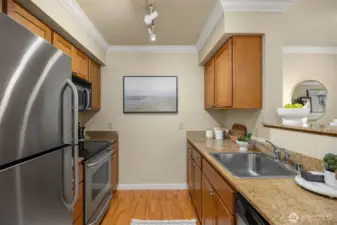 Kitchen with granite countertops, stainless steel appliances and good counter space.