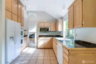 Enjoy a view from the kitchen’s eating area, with the living room’s wood fireplace visible in the background.