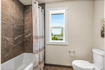 Separate shower room made private from the dual vanities in main hall bath,