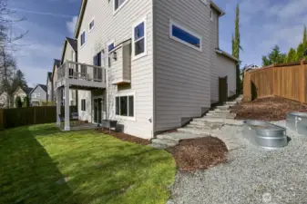 Custom side steps to yard and raised planters for easy gardening.