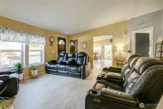 To the left of the front door, is access to the kitchen and dining area, and the primary suite is straight ahead.