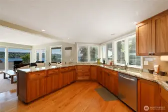 Spacious chef's kitchen with granite countertops, designer tile, breakfast bar, stainless steel appliances, and African Mahogany cabinets. All appliances stay.