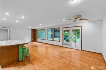 Oversized dining and living area off kitchen   with french doors leading to covered patio.