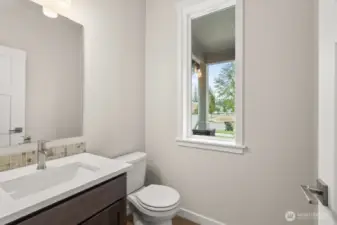 Main floor half bath, ideal for guests.