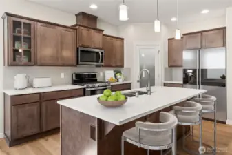 Virtually staged photo of kitchen, highlighting maple cabinetry and functional design.