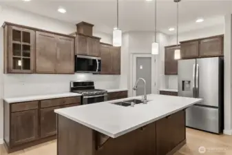 Plenty of overhead lighting in kitchen, perfect for prep cooking and entertaining. Refrigerator is also included!