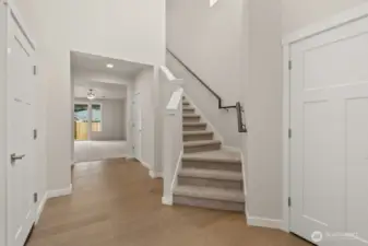 Foyer area with vaulted ceilings and stairway leading to 2nd floor