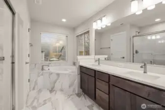 Five-piece primary bath features, tile flooring with full tiled tub deck for soaking tub, walk-in shower and dual vanity