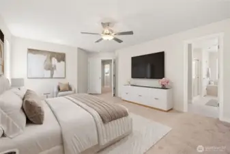 Virtually staged photo of primary bedroom highlighting ceiling fan and 5-piece bath