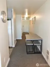 Dining Area leading to the hallway to the entry and bedroom.