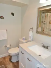 Nicely appointed bathroom w/ quartz vanity.