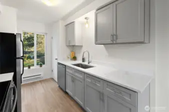 Kitchen has all new cabinets, undermount sink, faucet and quartz countertops.