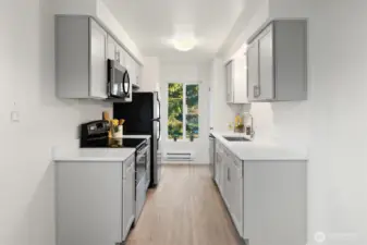 Kitchen has a closets on either side of window for pantry and storage.