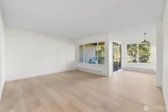 Living and dining room freshly updated with new flooring, trim, paint, heaters and lighting. Such an inviting space.